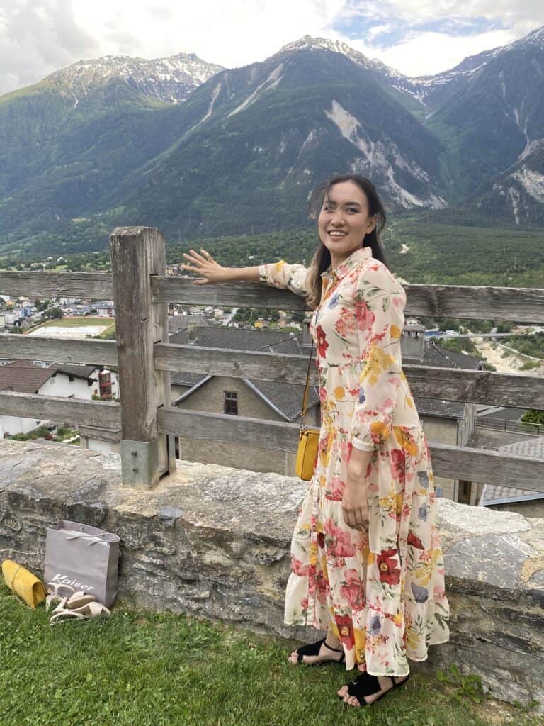 A woman standing in front of beautiful Swiss alps